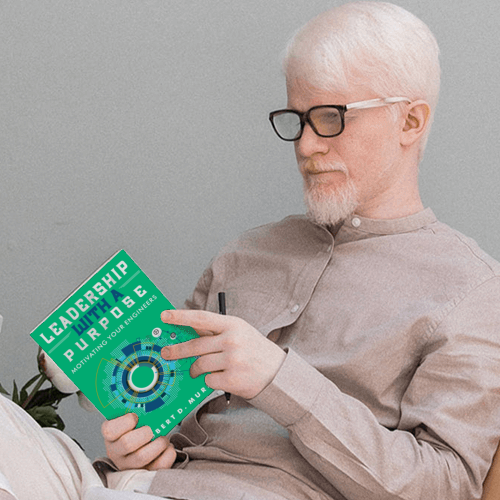 A man quietly reading Leadership With A Purpose: Motivating Your Engineers.